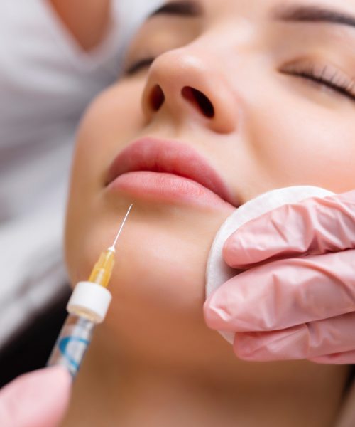 lip shape correction procedure in a cosmetology salon. The specialist makes an injection on the lips of the patient. Lip augmentation. lip shape correction procedure in a cosmetology salon. The specialist makes an injection on the lips of the patient. Lip augmentation